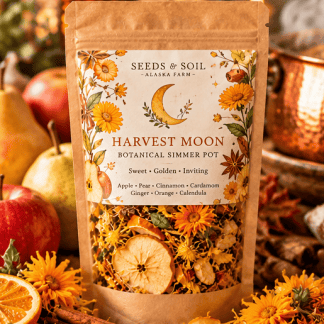 Harvest Moon fall simmer pot in kraft packaging with dried apple, pear, cinnamon, cardamom, and golden calendula flowers. Harvest Moon botanical simmer pot blend featuring dried orchard fruit, orange peel, calendula flowers, and aromatic autumn spices. Copper saucepan gently simmering dried apples, citrus, cinnamon, cardamom, and flowers for natural fall home fragrance. Harvest Moon fall simmer pot ingredients arranged with apples, pears, cinnamon sticks, cardamom pods, ginger, and calendula. Back of Harvest Moon botanical simmer pot packaging featuring product information, ingredients, and directions. Harvest Moon botanical simmer pot displayed in a cozy autumn farmhouse setting with seasonal flowers, dried fruit, and spices.